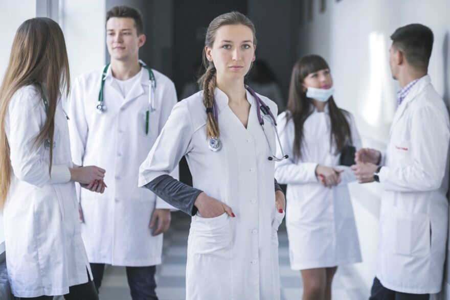 woman-standing-with-medic-colleagues