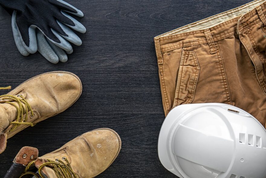 Builder clothes, worker uniform on wooden background, flat lay.